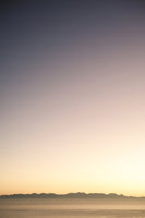 acrylic-print-sunset-over-distant-mountains
