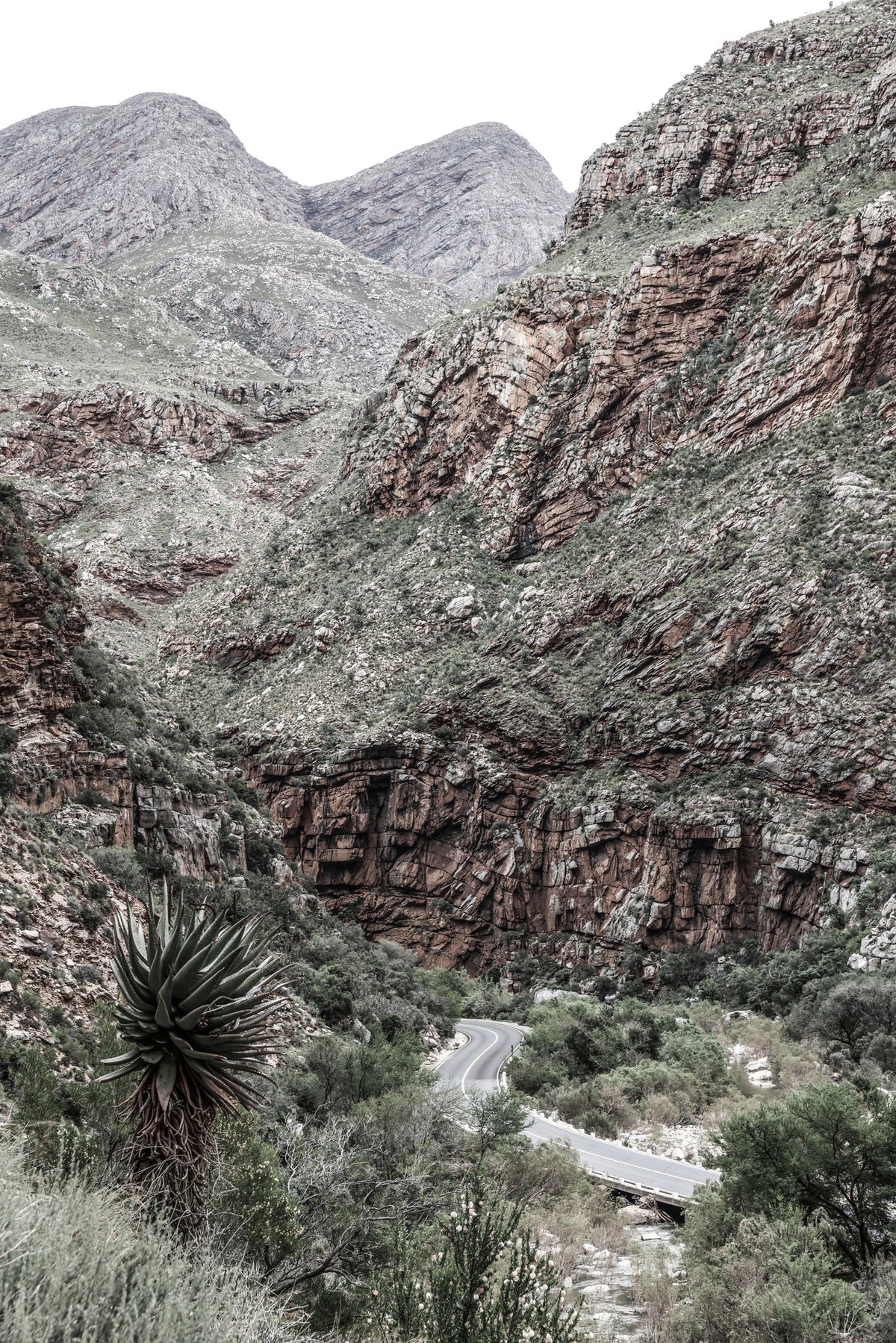 framedposter-print-mountain-road-through-a-rugged-canyon-landscape