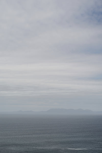 poster-print-tranquil-ocean-and-distant-horizon-under-a-clouded-sky